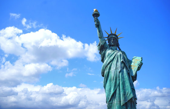  Statue of Liberty as a backdrop to the beautiful blue sky.