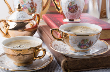 Antique porcelain coffee cups with hot coffee