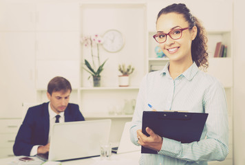 portrait of  business woman holding cardboard in office