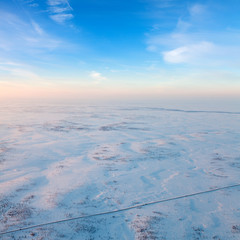 Road in winter tundra, top view