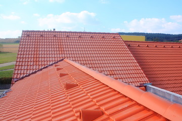The roof is covered with red roofs of concrete tiles