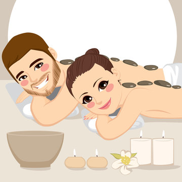 Attractive young couple on a spa enjoying hot stone massage treatment