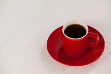 Red coffee cup on saucer