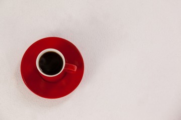Red coffee cup on saucer