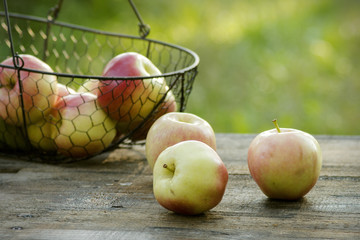 Fresh apples in a basket on table