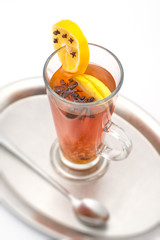 hot citrus drink with alcohol and orange slices and spices, winter drink, product photography for restaurant or cafe