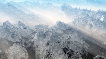 Snowy mountain peaks in mist in low sunlight.