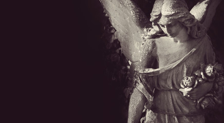sculpture of an angel with dark background - Powered by Adobe