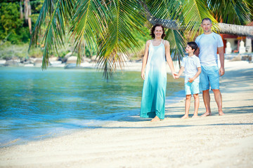 Young family of three having fun tropical beach, Koh Phangan island, Thailand