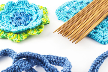 Crochet hooks and wool on white background