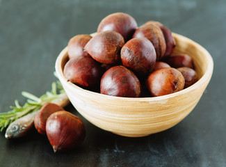 Fresh chestnuts in yellow bowl