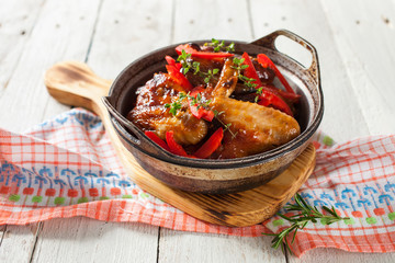 the baked chicken wings with a paprika and a thyme in a dish on a table, selective focus,copy space