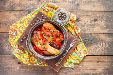 the baked chicken wings with a paprika and a thyme in a dish on a table, selective focus, the top view, copy space