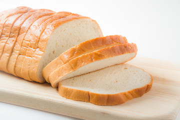 Fresh sliced bread on the wooden board in the kitchen. Healthy eating and lifestyle.