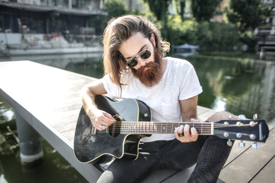 Hipster playing the guitar