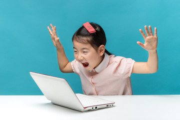 surprised, Cute asia little girl who enjoy the laptop computer o