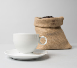 Coffee cup with a brown knitted coffee sack