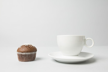 Coffee cup with a muffin