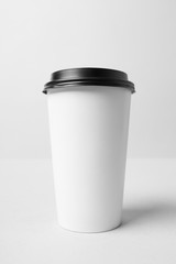 White paper cup with a black cap mockup