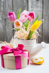 pink yellow tulips on rustic wooden background