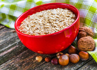 Oatmeal or oat flakes on dark wooden table