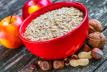 Oatmeal or oat flakes on dark wooden table