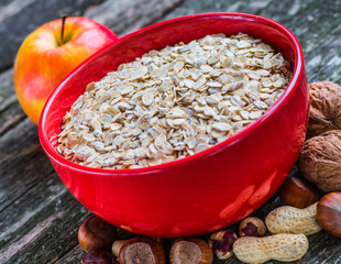Oatmeal or oat flakes on dark wooden table