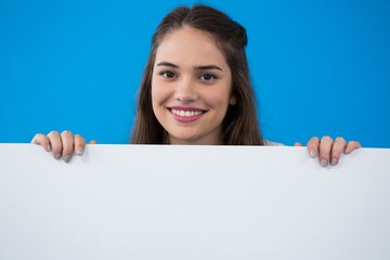 Fototapeta premium Woman holding a blank placard 