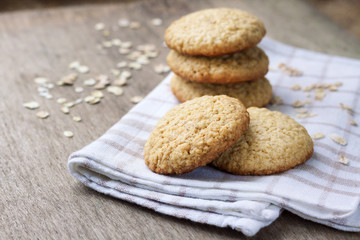 Homemade oatmeal cookies on checkered kitchen towel