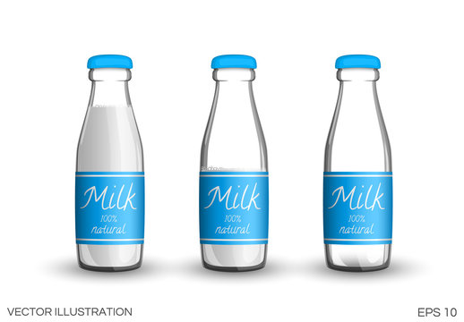 Glass bottles of transparent milk with labels