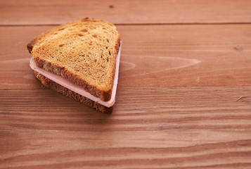 triangular sandwiches on wooden table
