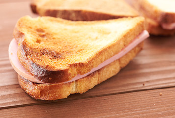 triangular sandwiches on wooden table