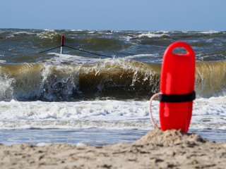Red flotation device (buoy) for water rescue at the beach.