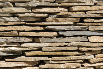 slate flagstone wall of large irregular pieces of stone ruins brown background detail