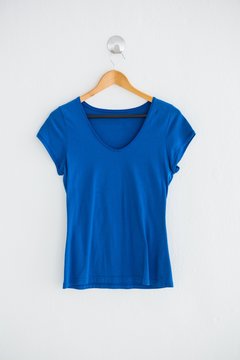 Blue t-shirt hanging on wall