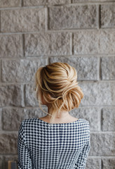 Blonde Woman hairdo french twist, rear view