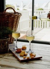 Two glasses of white wine with cheese, rustic, selective focus
