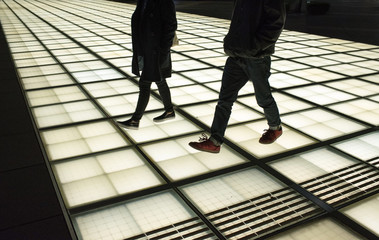 Couple walking in futuristic architecture in Tokyo