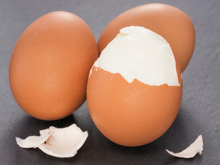 three boiled eggs on slate background