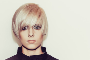 Woman with stylish short hairstyle on a light background