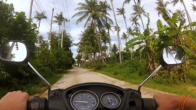 first person with hands guy on a motorbike rides in the jungles of Thailand and in the village of gopro