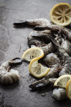 Raw prawns on dark textured background