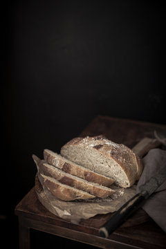 Sliced loaf of bread on wooden table