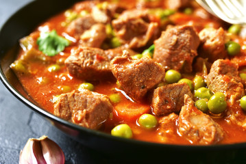 Veal stewed with vegetables in tomato sauce.