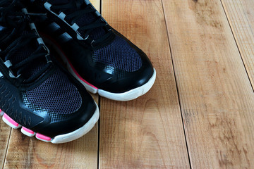 Black sport shoes on wooden.
