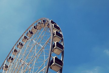 Part of Ferris wheel against blue sky