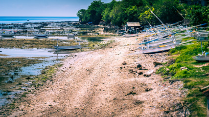 Fisher Boats at low tide near seaweed plantations algal - Nusa Penida, Bali, Indonesia
