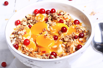 healthy breakfast rice porridge with mango puree, banana and granola