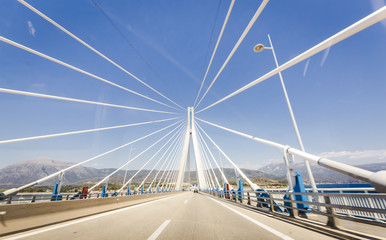 road to suspension bridge crossing Corinth Gulf strait, Greece