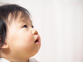 Asian cute baby girl  looking up